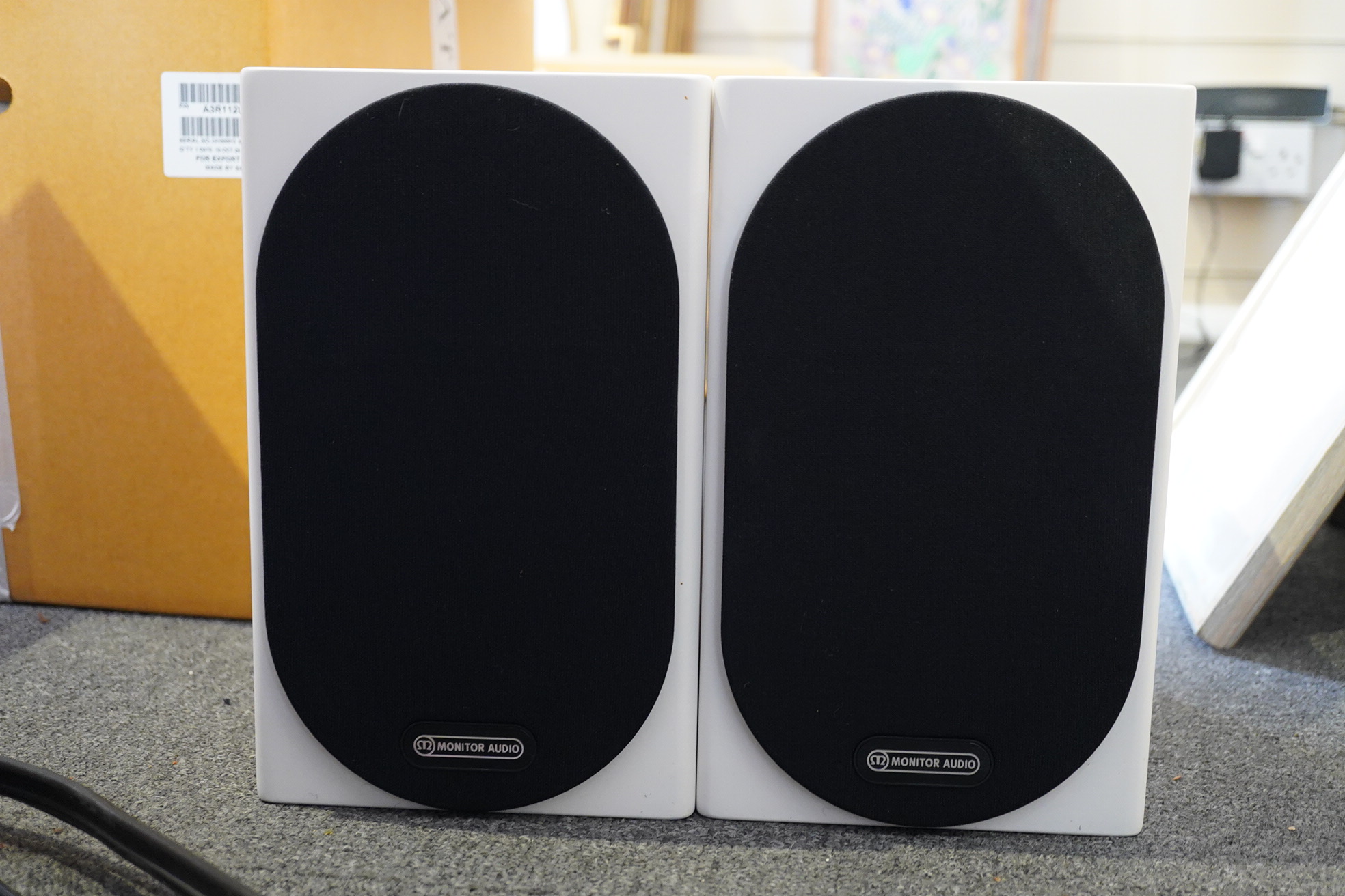 A pair of Monitor Audio Silver Series ‘Silver 50’ stereo monitor speakers in satin white cases, height 27cm, width 16.5cm, depth 25cm, together with the silver series specification booklet and two related audio cables